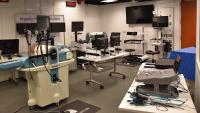 Simulation room with VR training equipment and monitors.
